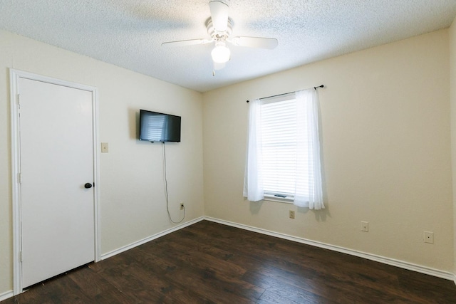 unfurnished bedroom featuring ceiling fan, a textured ceiling, and dark hardwood / wood-style flooring