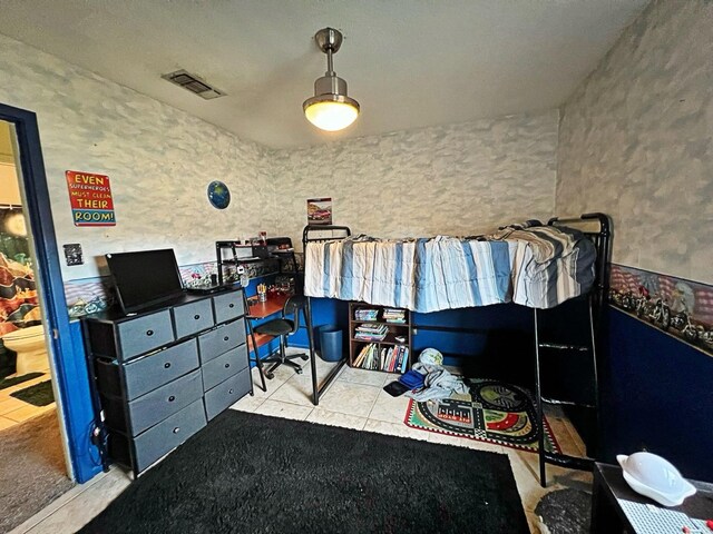 bedroom featuring light tile patterned floors