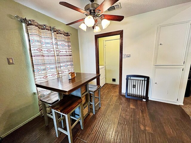 dining area featuring ceiling fan, dark hardwood / wood-style flooring, and a textured ceiling