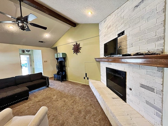 living room with a fireplace, carpet flooring, vaulted ceiling with beams, ceiling fan, and a textured ceiling