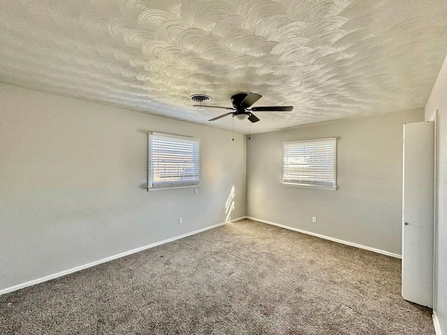 unfurnished room with ceiling fan, a textured ceiling, and carpet