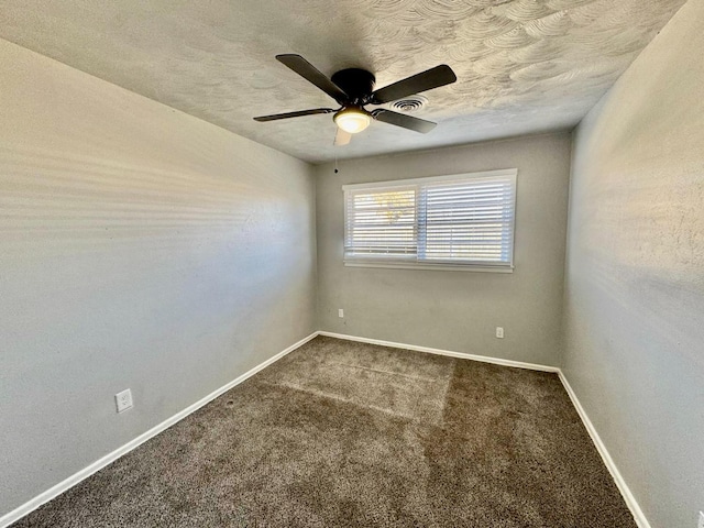 carpeted empty room featuring ceiling fan and a textured ceiling