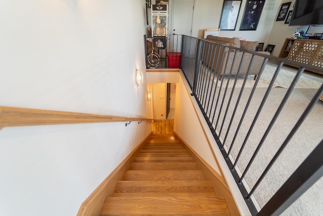 stairs featuring wood-type flooring