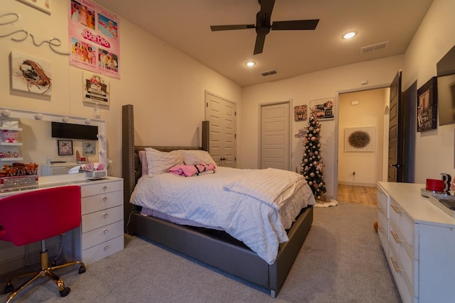 carpeted bedroom featuring a closet and ceiling fan