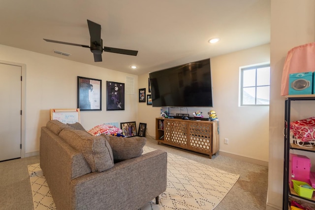 carpeted living room featuring ceiling fan