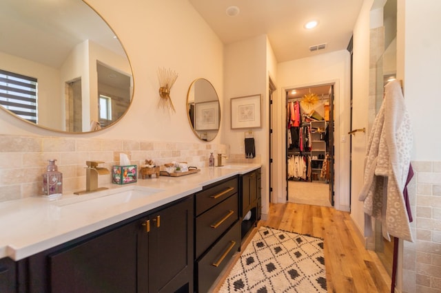 bathroom with tasteful backsplash, vanity, and hardwood / wood-style floors