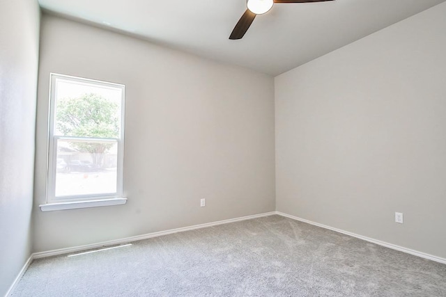 carpeted spare room with a healthy amount of sunlight and ceiling fan