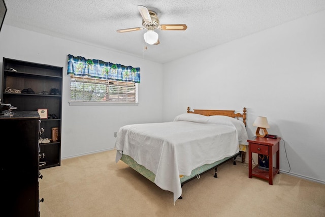 carpeted bedroom with a textured ceiling and ceiling fan