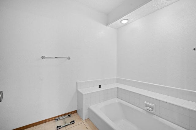 bathroom with tile patterned floors and a bathtub