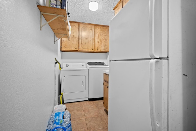 laundry area with separate washer and dryer, light tile patterned floors, and a textured ceiling