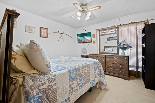 carpeted bedroom featuring a textured ceiling and ceiling fan