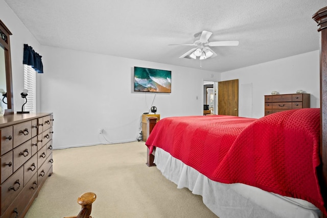 carpeted bedroom featuring a textured ceiling and ceiling fan