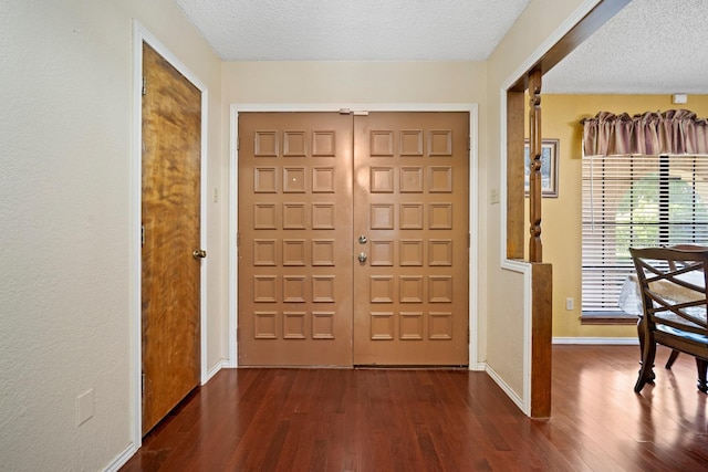 entrance foyer featuring dark wood-type flooring and a textured ceiling