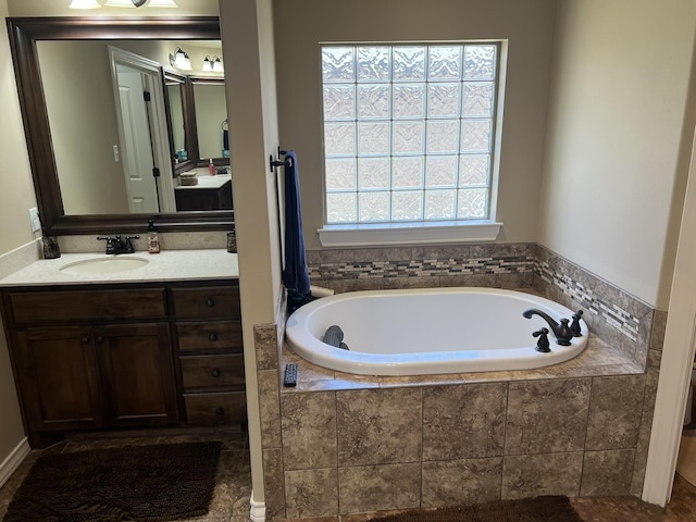full bathroom with a bath and vanity