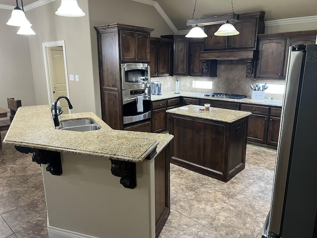 kitchen featuring decorative backsplash, stainless steel appliances, ornamental molding, a sink, and a center island with sink