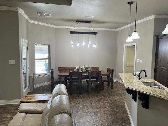 dining room featuring crown molding, visible vents, and baseboards