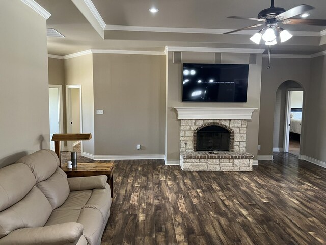 living room featuring wood finished floors, ceiling fan, crown molding, and arched walkways
