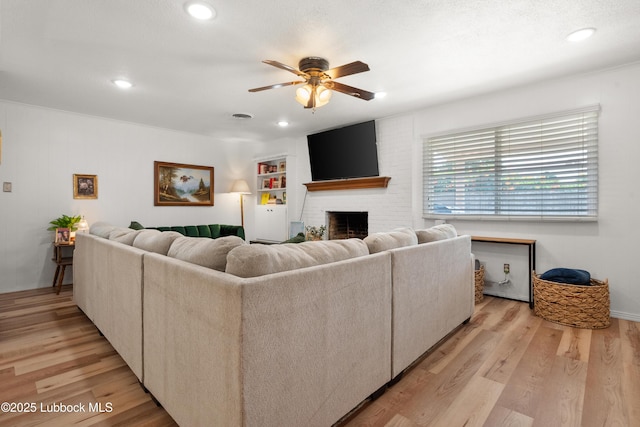 6405 Joliet Ave, Lubbock, TX 79413 - living area with ceiling fan, recessed lighting, a fireplace, and light wood finished floors