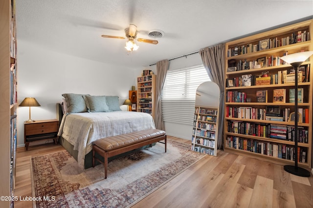 6405 Joliet Ave, Lubbock, TX 79413 - bedroom featuring wood finished floors, a ceiling fan, and a textured ceiling