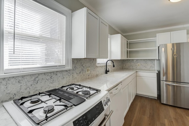 kitchen with sink, stainless steel fridge, dishwasher, white cabinetry, and range with gas stovetop