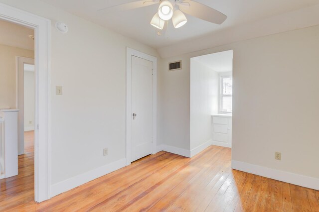 spare room with light hardwood / wood-style flooring and ceiling fan