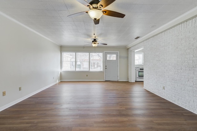 unfurnished living room with crown molding, brick wall, and dark hardwood / wood-style flooring