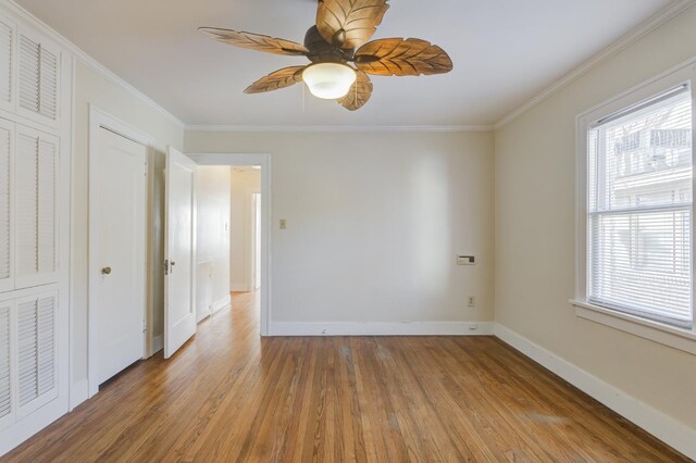 spare room featuring crown molding, ceiling fan, and hardwood / wood-style floors