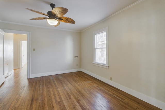 empty room featuring crown molding, hardwood / wood-style flooring, and ceiling fan