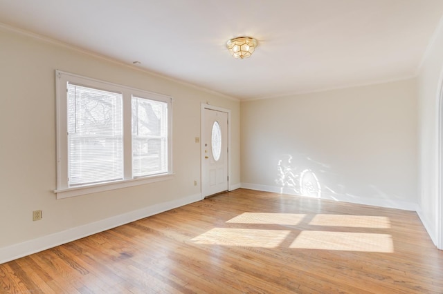 foyer entrance featuring ornamental molding and light hardwood / wood-style floors