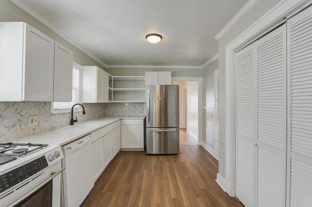 kitchen featuring white cabinetry, appliances with stainless steel finishes, sink, and backsplash