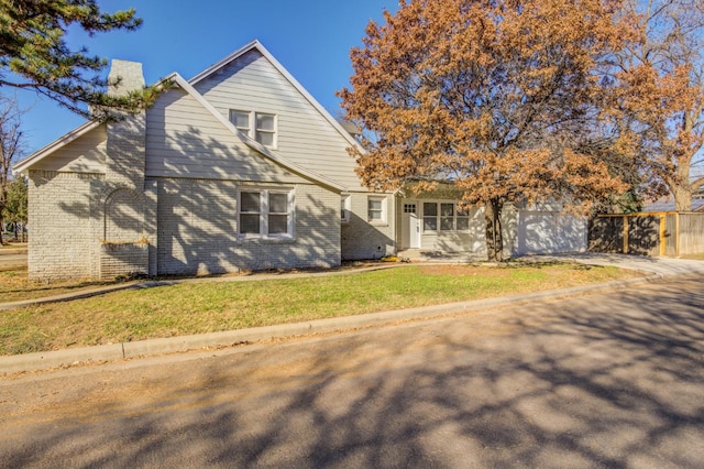 view of front of home with a garage and a front lawn