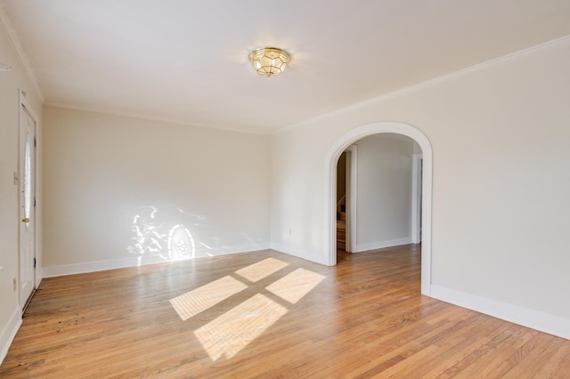 unfurnished room featuring crown molding and light hardwood / wood-style floors