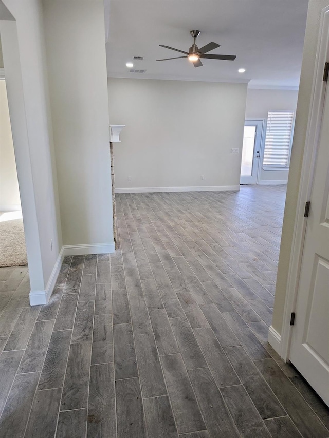 empty room featuring ceiling fan, ornamental molding, and dark hardwood / wood-style flooring