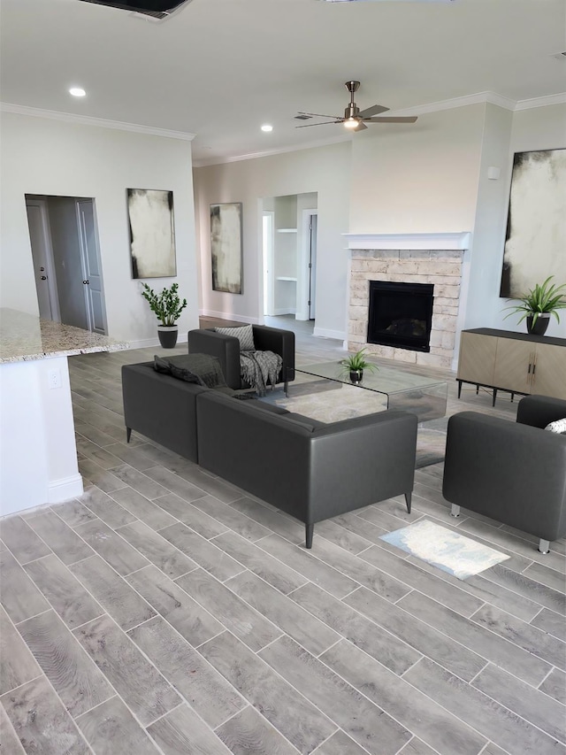 living room featuring crown molding, a stone fireplace, and ceiling fan