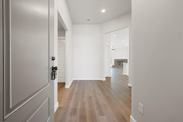 corridor with light wood-type flooring