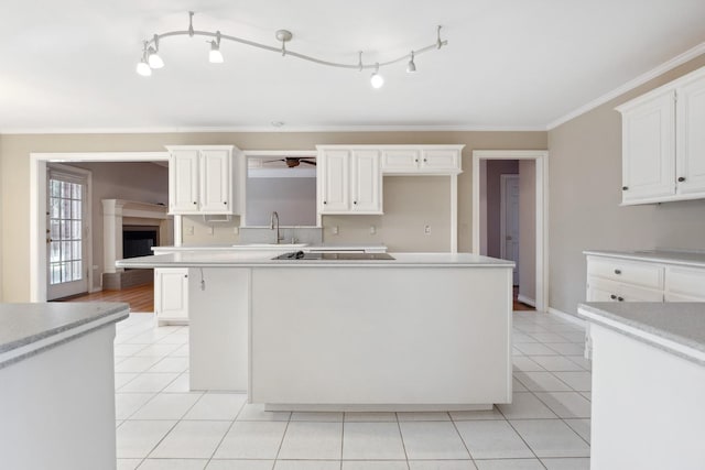 kitchen featuring ornamental molding, white cabinets, and a kitchen island