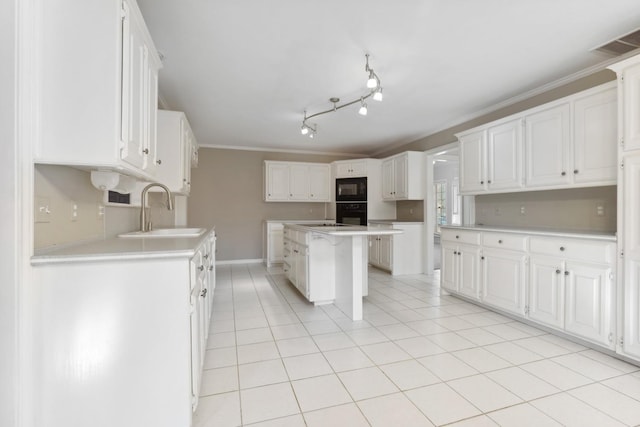 kitchen with white cabinetry, black appliances, and a center island