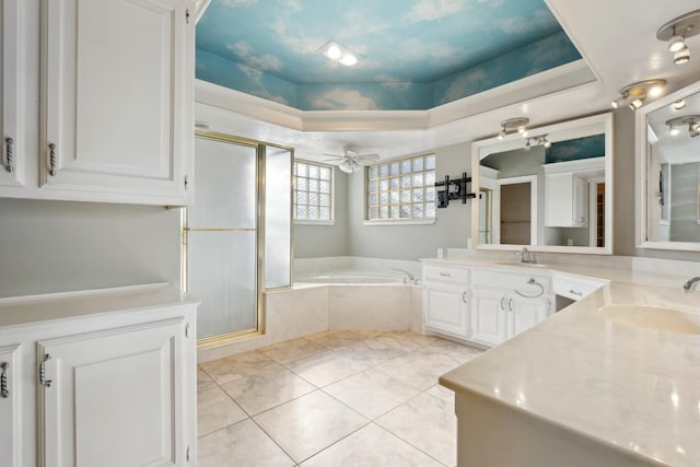 bathroom with ceiling fan, tile patterned flooring, vanity, plus walk in shower, and a raised ceiling