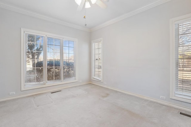 carpeted empty room featuring crown molding, plenty of natural light, and ceiling fan