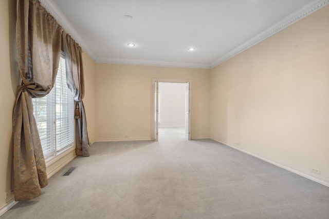 carpeted spare room featuring crown molding