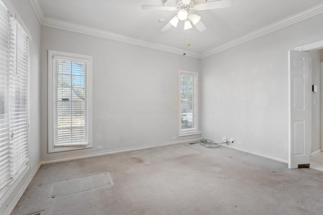 spare room with ornamental molding, light colored carpet, and ceiling fan