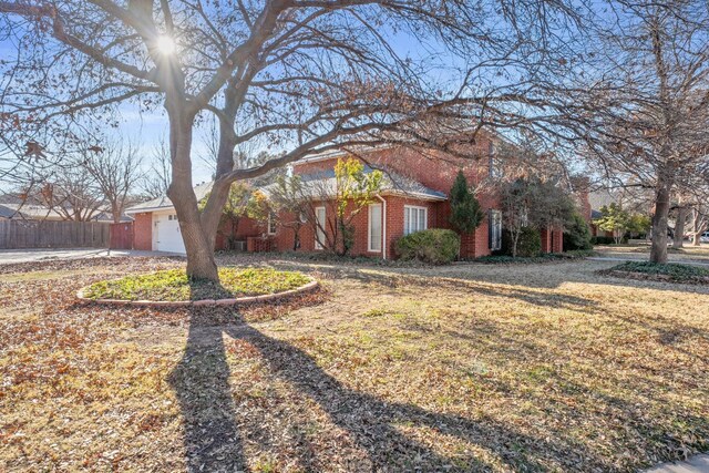 view of front of property featuring a garage and a front lawn