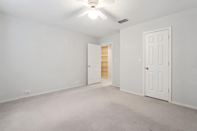 carpeted spare room featuring ceiling fan