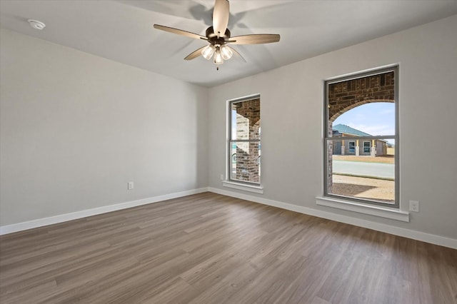 spare room featuring ceiling fan and hardwood / wood-style floors