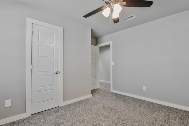 unfurnished bedroom with ceiling fan and light colored carpet