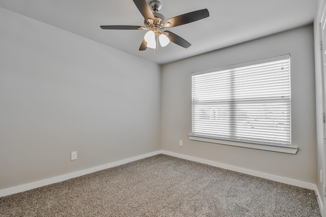 spare room with ceiling fan and carpet