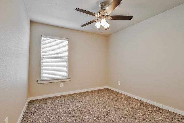 carpeted spare room with ceiling fan