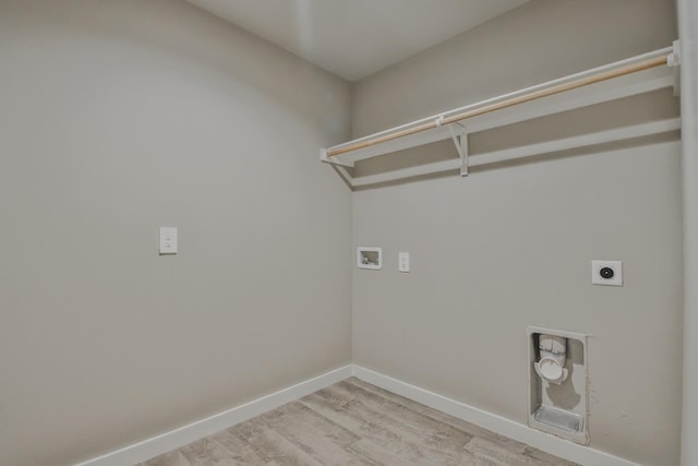 laundry area featuring washer hookup, light hardwood / wood-style floors, and hookup for an electric dryer