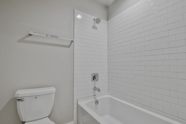 bathroom featuring tiled shower / bath and toilet