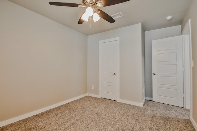 unfurnished bedroom featuring ceiling fan and light colored carpet